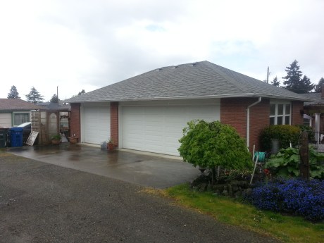 A. House in the city with three car garage.